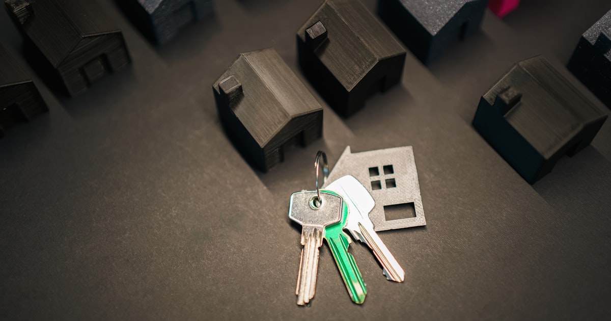 House keys beside model homes, symbolising the rent versus buy decision in the Chandigarh Tricity