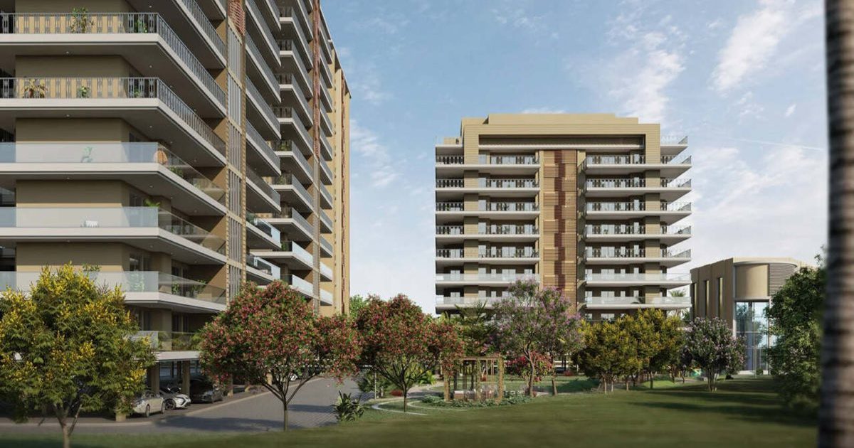 Rendering of high-rise residential towers beside a landscaped lawn at The Zirk, Zirakpur